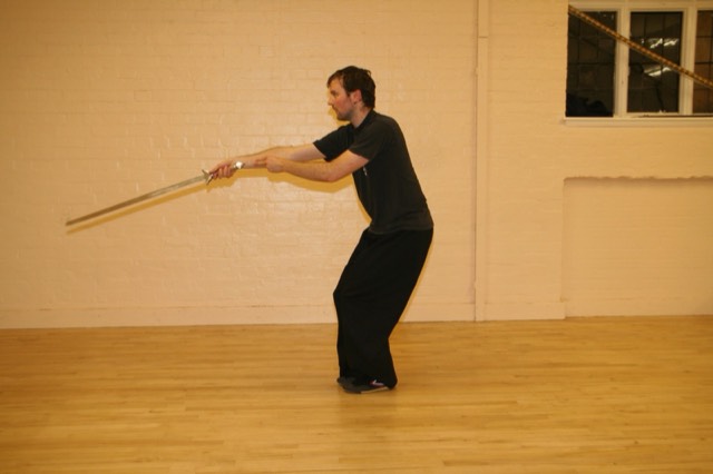 A student extending a staff in a long horizontal strike