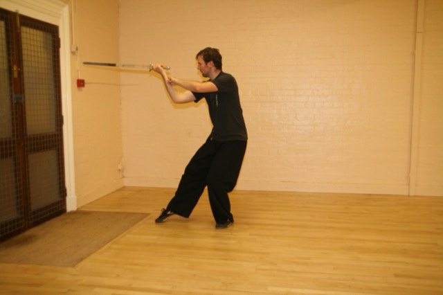 A student in a sweeping staff posture
