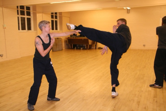 A student throwing a high kick