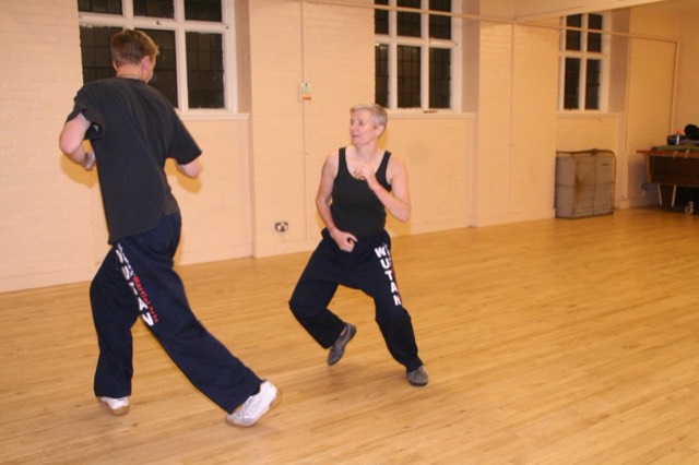 Two students circling each other while sparring
